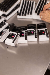 Cannabis packaging costs reduction through volume consolidation and compliant labeling at a California facility